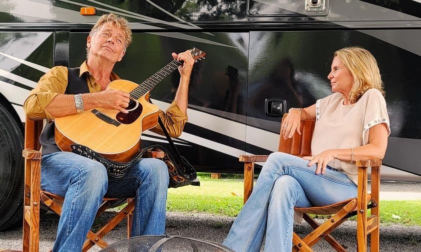 John Schneider with guitar, his official app was built by MAC